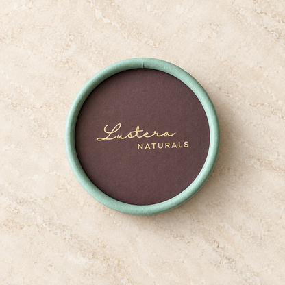 Top view of the mint-green and plum Lustera Naturals conditioner box on a warm ivory stone surface