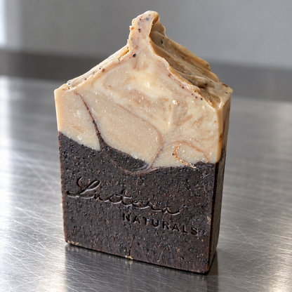 Angled view of a Dark Roast soap bar on a brushed steel surface
