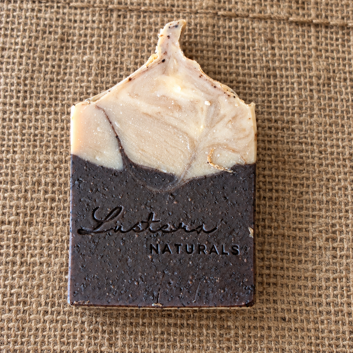 Dark Roast coffee soap bar photographed on natural hessian fabric