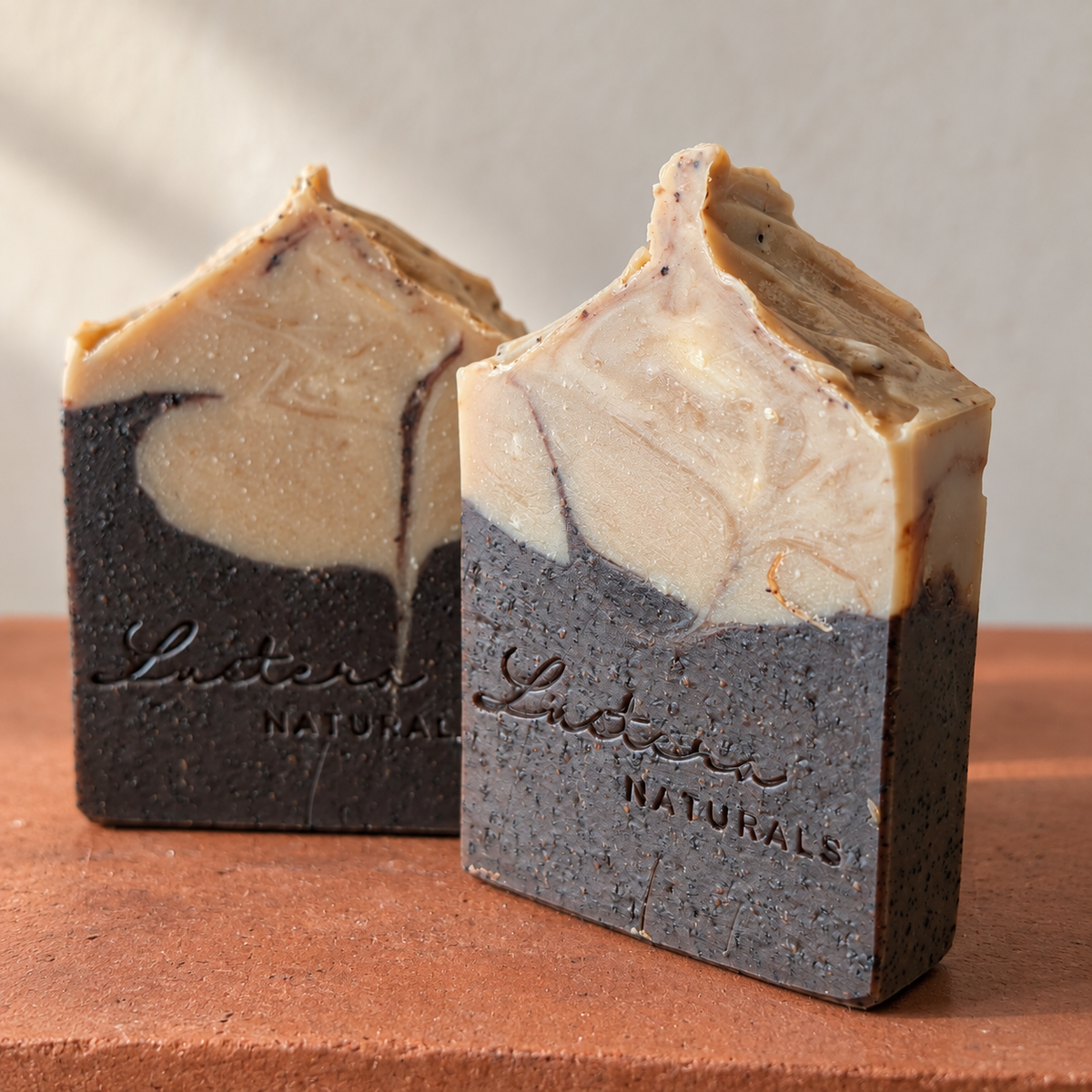 Two Dark Roast handmade soap bars on a terracotta surface