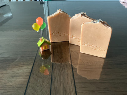 Three upright Lustera Naturals Lavender soap bars showing their natural peach-cream colour and handmade tops