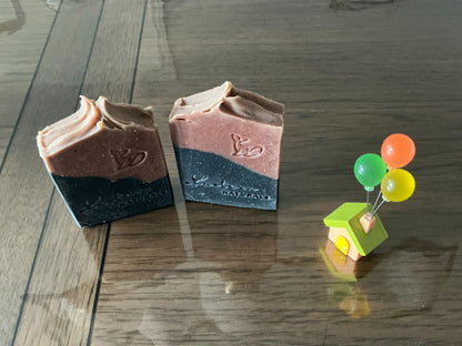 Overhead view of two standing Meliya Aanmai soap bars with handcrafted textured tops