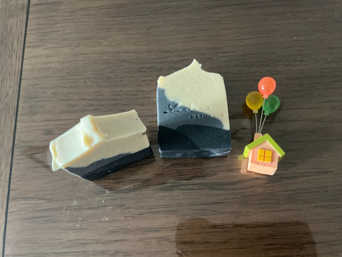 Actual Lustera Naturals Obsidian soap bars with charcoal, slate-grey and ivory layers