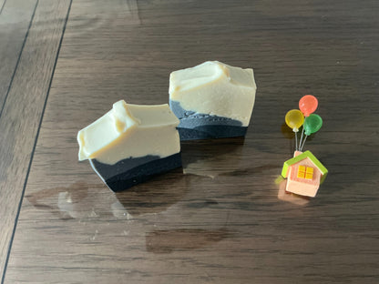Obsidian handmade soap bars showing their sculpted cream tops and dark layered bases