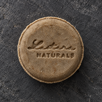 Top view of the Scalp Sanctuary shampoo bar on charcoal slate